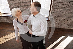 Passionate senior couple tangoing in the dance studio