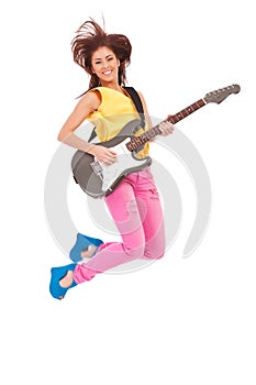 Passionate woman guitarist jumps in the air