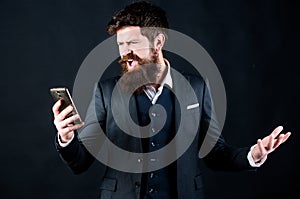 Passionate about work. Bearded man shouting at smartphone. online and agile. brutal caucasian hipster with moustache