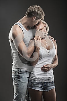 Passionate young couple in love on dark photo