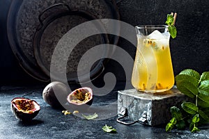 Passionfruit iced green tea or lemonade with lime and mint. Tropical refreshing cold drink