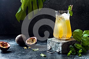 Passionfruit iced green tea or lemonade with lime and mint. Tropical refreshing cold drink