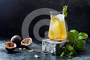 Passionfruit iced green tea or lemonade with lime and mint. Tropical refreshing cold drink