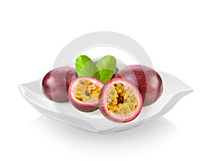 Passionfruits in ceramic plate on white background