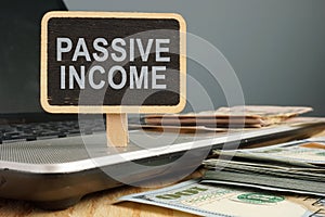 Passive income concept. Notebook and stack of cash