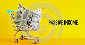 Passive income is shown using the text and photo of trolley with dollars