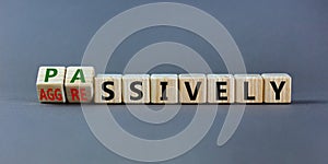 Passively or aggressively symbol. Turned wooden cubes and changed the word `passively` to `aggressively`. Psychological and photo