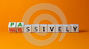 Passively or aggressively symbol. Turned wooden cubes and changed the word passively to aggressively. Psychological and passively photo