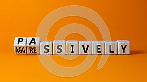 Passively or aggressively symbol. Turned wooden cubes and changed the word passively to aggressively. Psychological and passively photo