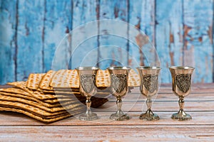 Passover background four glasses wine and matzoh jewish holiday bread over wooden board