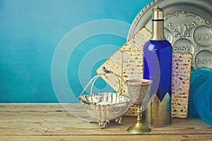 Passover background with matzo and wine on wooden vintage table. Seder plate with hebrew text