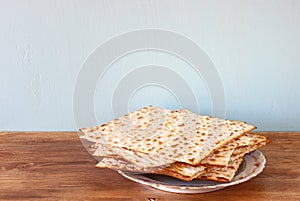 Passover background. matzoh (jewish passover bread) over wooden background.