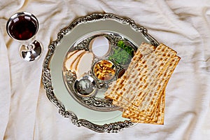 Passover background with wine bottle, matzoh, egg and seder plate photo