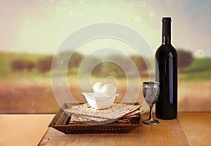 Passover background. wine and matzoh (jewish passover bread) over wooden background