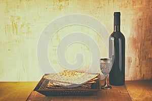 Passover background. wine and matzoh (jewish passover bread) over wooden background