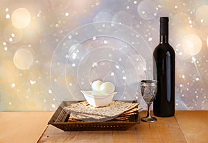 Passover background. wine and matzoh (jewish passover bread) on wooden table