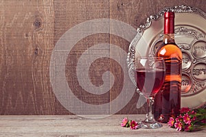 Passover celebration with wine and seder plate over wooden background