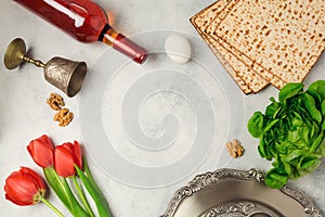 Passover holiday concept seder plate, matzoh and wine bottle on bright background.