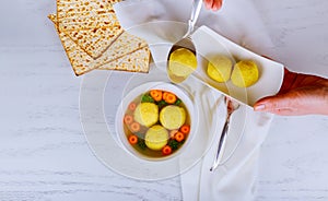 Passover matzah balls in a pot of soup during the Jewish holiday of Pesach photo