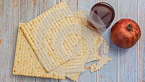 Passover matzoh jewish holiday bread, glass kosher wine over wooden table