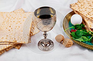 Passover matzoh jewish holiday bread, glasses kosher wine over wooden table