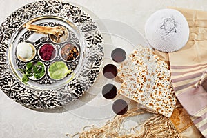Passover Seder plate with traditional food, walnuts, matza and wine on grunge background