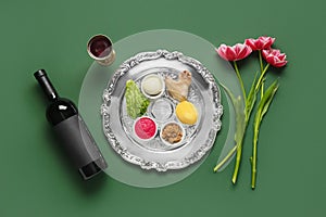 Passover Seder plate with traditional food, wine and flowers on color background