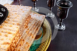 Passover tradition matzah flatbread bread, kosher wine cup, a jewish pesach attributes