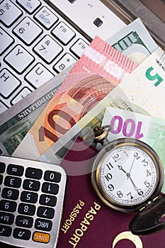 Passport of a citizen of the Turkey beside Euro banknotes, calculator keyboard and pocket watch