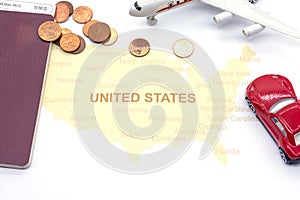 Passport compass and coins on a American map. business travel concept