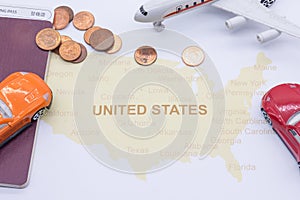 Passport compass and coins on a American map. business travel concept