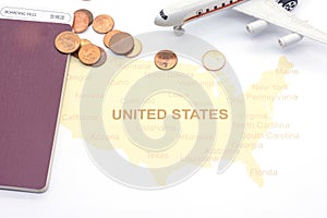 Passport compass and coins on a American map. business travel concept