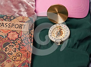 passport ,compass and pink backpack for tourist travel,packing clothes for the trip