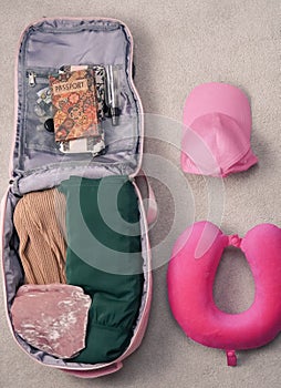 passport ,compass and pink backpack for tourist travel,packing clothes for the trip