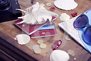 Passport, credit card, travel accessories, seashells. Vacation documents. Turism concept. Selective focus.