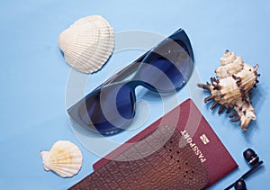 Passport, credit card, travel accessories, seashells. Vacation documents. Turism concept. Selective focus.