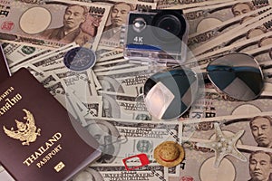 Passport ,eye glasss,small relax hat ,action camera and mobile socket sim place on banknote for the time of relaxation and tourism
