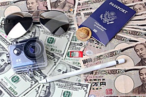 Passport ,eye glasss,small relax hat ,action camera ,stylus, and mobile socket sim place on banknote for the time of relaxation