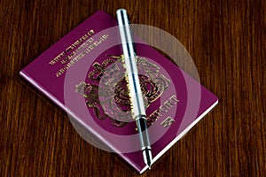 Passport with Fountain Pen on an old Varnished Wood Surface