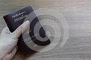 Passport in hand prepare to travel and copy space on wood desk