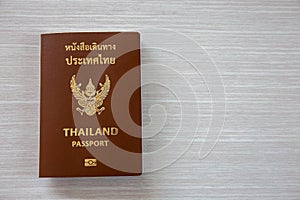 Passport for International travel and business laid out on a wooden background. Copy space background