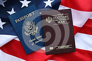 Passport of Iran Republic with US Passport on United States of America folded flag