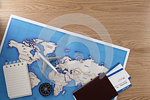 Passport with map on wooden texture background. Travel concept background. Flat lay