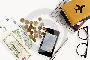 Passport money phone with map and glasses on white background,