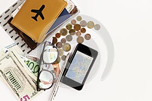 Passport money phone with map and glasses on white background,