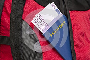 Passport and money in the pocket of a backpack. Travel concept