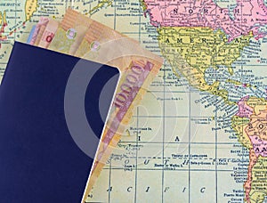 Passport with money on world map background