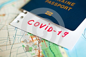 Passport and note with Covid-19 inscription