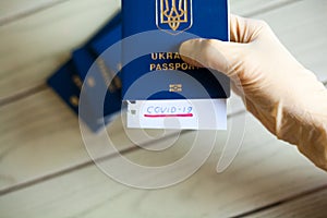 Passport and note with Covid-19 inscription