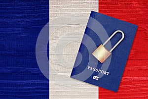 Passport and padlock on the background of the flag of France. Ban on leaving the country. Travel abroad is closed. French flag and